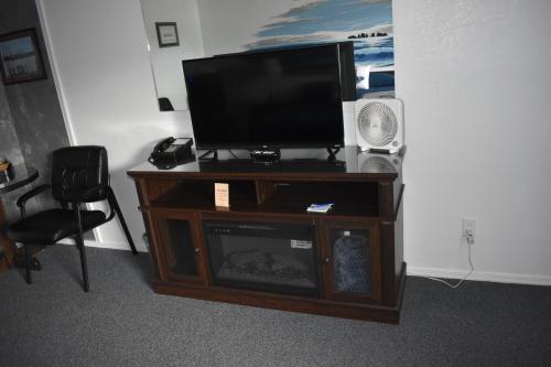a flat screen tv sitting on top of a entertainment center at Lighthouse Cove Inn in Bandon