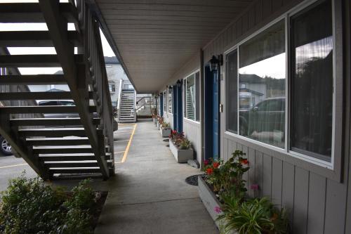 a hallway of a building with potted plants on it at Lighthouse Cove Inn in Bandon