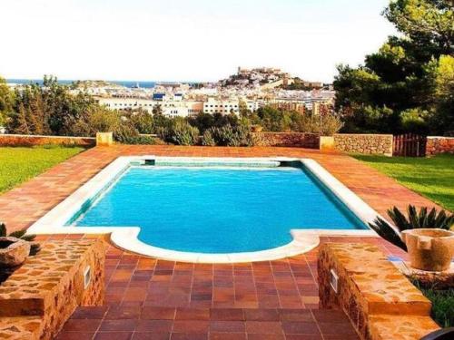 a swimming pool in the yard of a house at Tranquil Villa in Ibiza with Swimming Pool in Ibiza Town