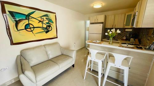 a living room with a couch and a kitchen at Compact Haven with Private Entrance and FREE Parking and Laundry in Ponce