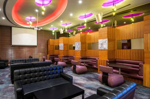 a conference room with leather chairs and a screen at Crowne Plaza Doha - The Business Park by IHG in Doha