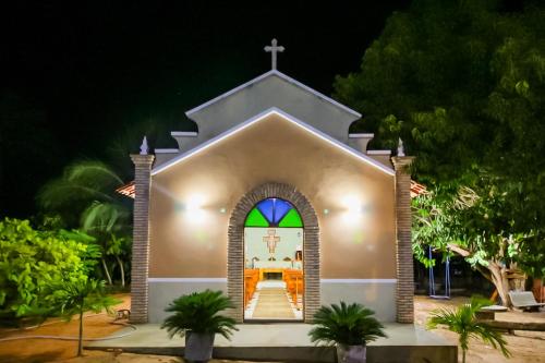 a small church with a stained glass window at Pousada Recanto Beach in Camocim