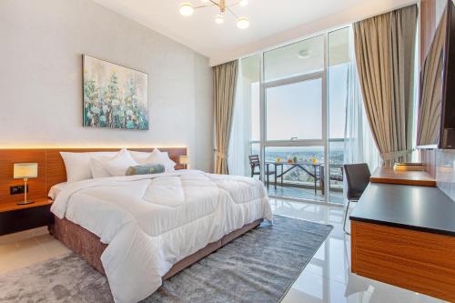 a bedroom with a bed and a desk and a window at Live in the middle of Lagoons and Sea in Ras al Khaimah