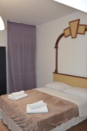 a bedroom with a bed with two towels on it at Fly me to Venice in Campalto