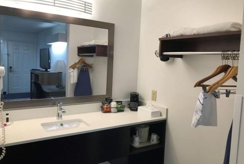 a bathroom with a sink and a mirror at Baymont by Wyndham Anderson Clemson in Anderson