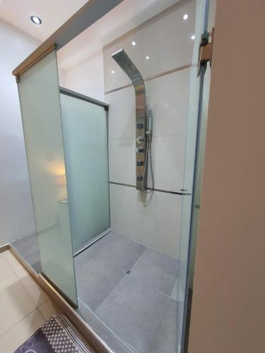 a shower with a glass wall in a bathroom at GOLDEN SKY in Talara
