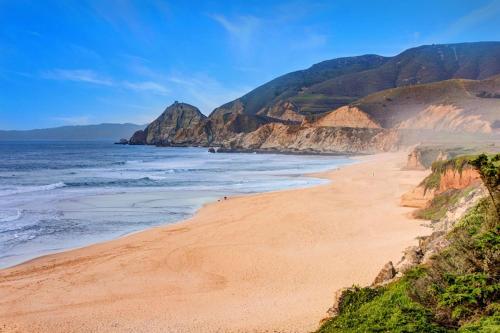 a beach with a view of the ocean and mountains at Stunning Oceanview Coastal Home Beach Trails Family Activities in Montara