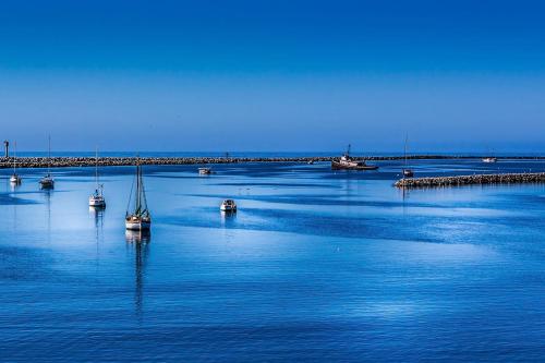 a group of boats in a large body of water at Now Trending - Entire Beach Home Walk to Beaches Restaurants Activities in Half Moon Bay