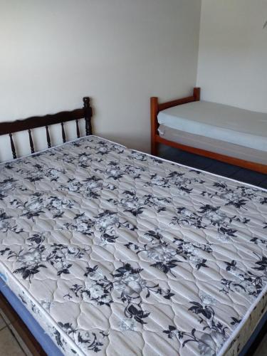 a bed in a room with two beds in it at Casa na praia in Itapoa