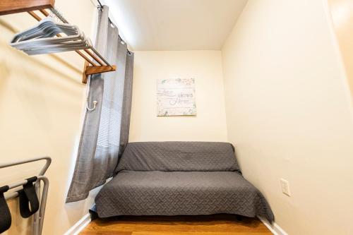 a small bedroom with a bed in a room at Shefah Hotel in Union City