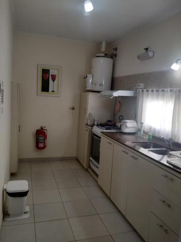 a small kitchen with a sink and a stove at north beach depto 6 in Colón