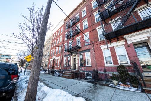 a snow covered street with a red brick building at Shefah Hotel in Union City