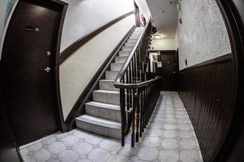 a hallway with a staircase in a building at Shefah Hotel in Union City