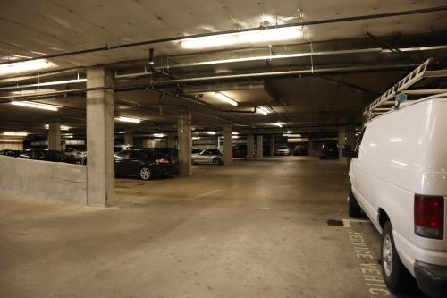 a parking garage with a white van parked in it at Renu Suites at The Burlington Portland in Portland
