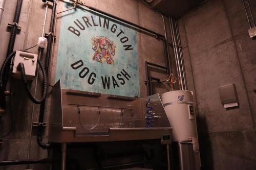 a washing machine and a sign on a wall at Renu Suites at The Burlington Portland in Portland
