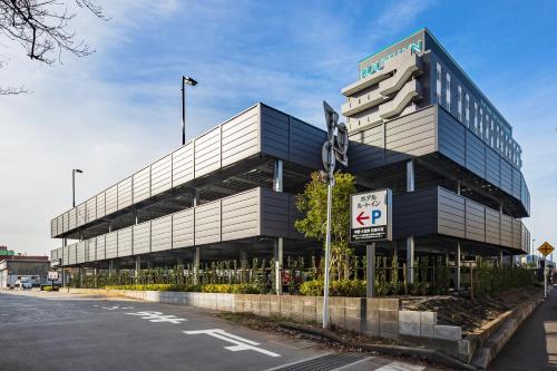 a large building with a parking sign in front of it at Hotel Route Inn Noda -Kokudo 16 Gouzoi- in Noda