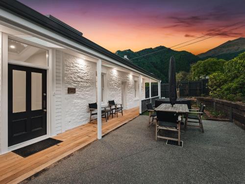 a patio with a table and chairs on a house at Stonehill Villa - 5 Bed in Queenstown
