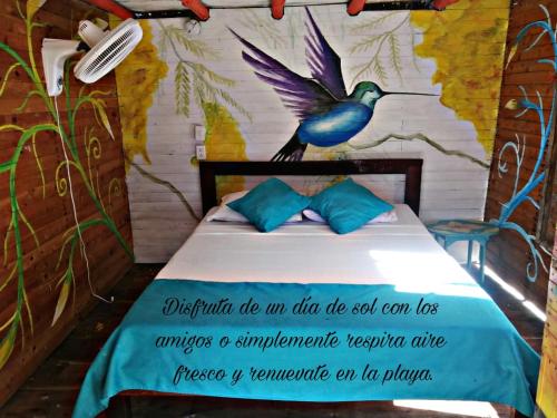 a bed with a picture of a bird on it at The Wizard & Bar BARU in Playa Blanca