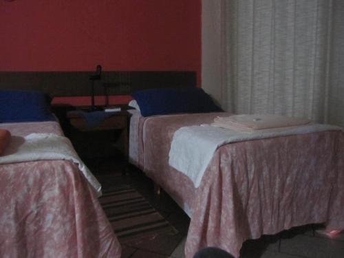 Tempat tidur dalam kamar di Pousada Vento Sul