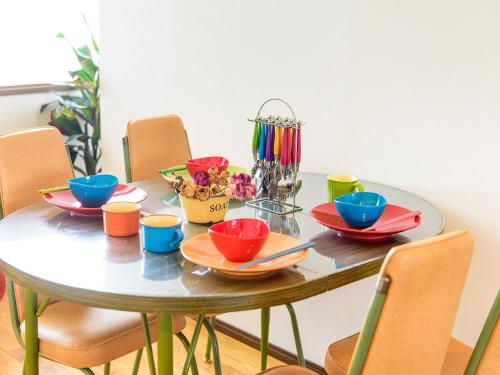 a table with colorful bowls and plates on it at El Sol Town Okinawa in Chatan