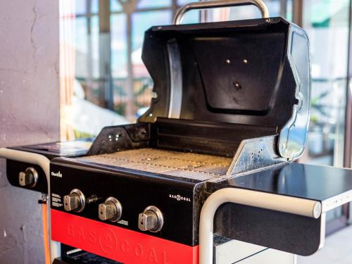 a black grill with a container on top of it at El Sol Town Okinawa in Chatan