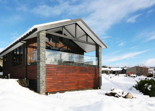 a small house in the snow with a roof at Lake Views at Antler Lodge in Lake Tekapo