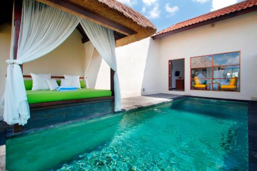 een slaapkamer en een zwembad in een villa bij Alam Puisi Villa Ubud in Ubud
