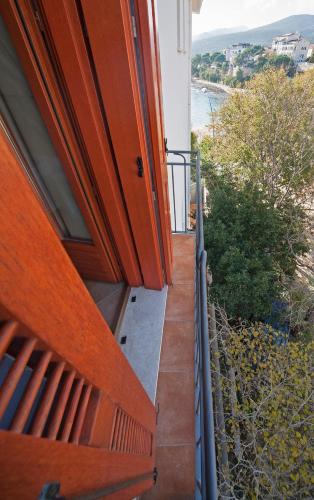 a stairway leading up to a house with a balcony at BUE MARINO Hotel & Roof Lounge in Cala Gonone