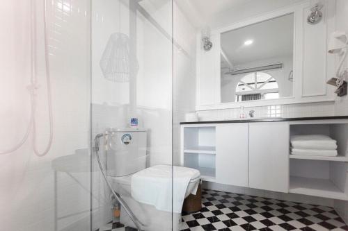 a bathroom with a toilet and a glass shower at R1 Nimman Hotel Chiangmai in Chiang Mai