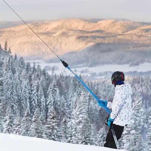 a person holding a ski pole on top of a mountain at Villa Stuga in Hammarstrand
