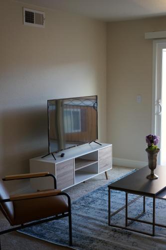 a living room with a tv and a coffee table at Sleepover 1BD 1BA Oklahoma City Apartments in Oklahoma City