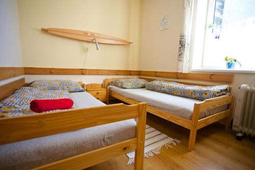 a bedroom with two beds and a surfboard on the wall at Ski apartmány Spiežovec Donovaly in Donovaly