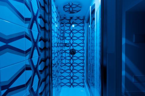 a hallway in a blue room with a door at Monte Brusara Relais in Ravello
