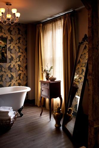 a bathroom with a bath tub and a window at The Crown And Thistle, Abingdon in Abingdon