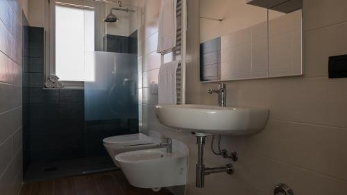 ein Bad mit einem Waschbecken und einem WC in der Unterkunft Appartamenti BluMare in Diano Marina