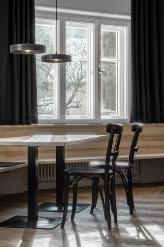 a table and two chairs in front of a window at Casa al Sole in Ortisei
