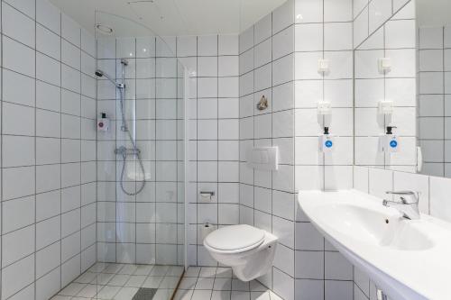 een witte badkamer met een toilet en een wastafel bij Vøringfoss Hotel in Eidfjord