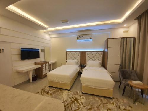 Postel nebo postele na pokoji v ubytování فندق المستقبل للشقق الفندقية ALMUSTAQBAL HOTEL Apartments
