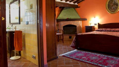 a bedroom with a bed and a fireplace at FRANTUSA 6&2, Emma Villas in Volterra