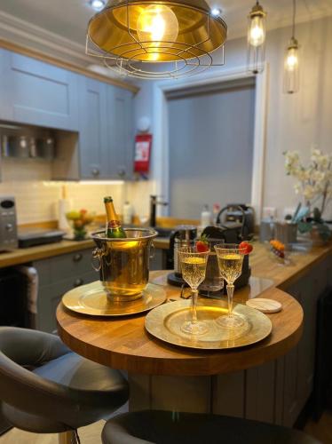 a table with two glasses on it in a kitchen at OurHaus in Beverley
