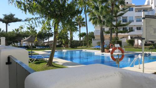 a swimming pool at a resort with a no swimming sign at Casa Agnethe in Fuengirola