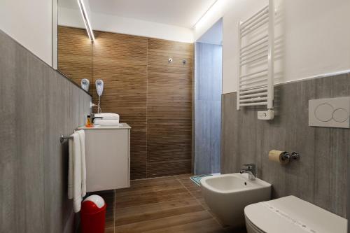 a bathroom with a white toilet and a sink at Centro Vacanze Pra' delle Torri in Caorle
