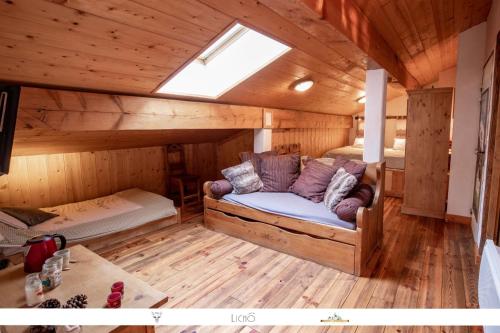 a room with a couch in the middle of a cabin at Chez Mamie Anna (B&B et Chalet) in Bessans