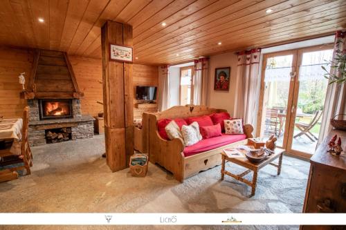 a living room with a couch and a fireplace at Chez Mamie Anna (B&B et Chalet) in Bessans