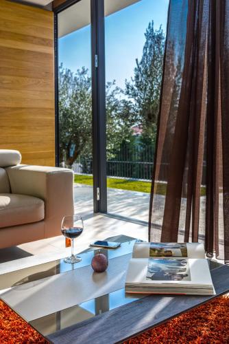 a living room with a glass table and a couch at Golden Rays Luxury Villas & Apartments in Primošten