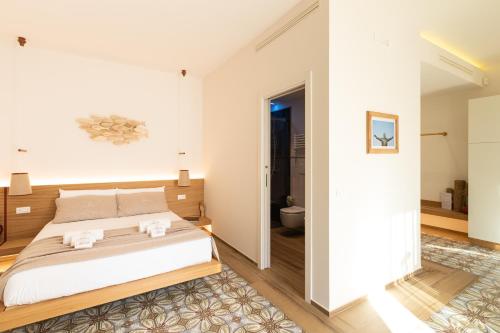 a bedroom with a bed and a bathroom at Dimora Labbate in Polignano a Mare