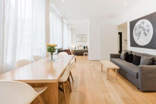 a living room with a table and a couch at Oxford Circus Designer Apartment in London