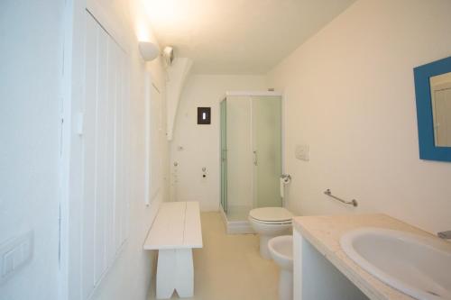 a white bathroom with a toilet and a sink at MASSERIA SCALEDDA in Manduria