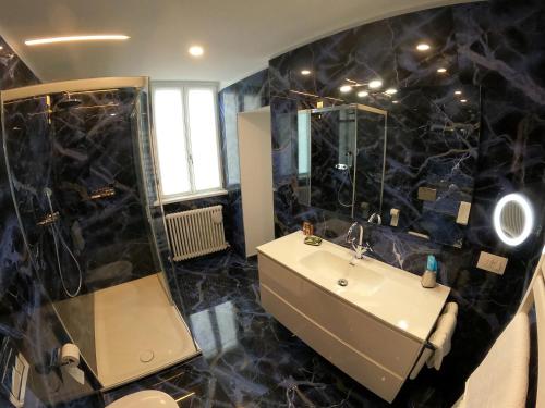 a bathroom with a sink and a shower at La Casa sul Lago Lecco 2 in Lecco