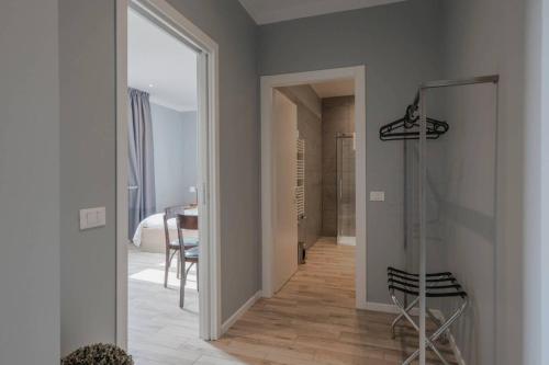 a hallway with a door leading to a room with a table at Al Binario Brescia in Brescia